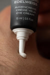 Close-up of Lumazen Nourishing Edelweiss Eye Cream being squeezed from the 15 ml tube onto skin