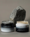 The Day & Night Duo set: Lumazen Anti-Aging Edelweiss Day Cream and Soothing Detox Edelweiss Night Cream jars on grey stone
