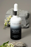 Lumazen Revitalizing Edelweiss Hair Tonic, 50 ml bottle on grey stone with alpine flowers